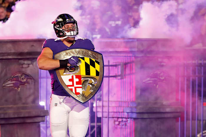 Baltimore Ravens fullback Patrick Ricard (42) carries the Ravens shield onto the field during player introductions prior to the Ravens game against the Tennessee Titans in a AFC Divisional Round playoff football game at M&T Bank Stadium.
